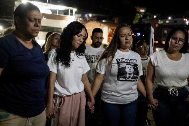Relatives of political prisoners mourn during a vigil outside El Rodeo I prison in Guatire, Miranda state, Venezuela, on February 12, 2026. Venezuela's legislature on February 12 postponed the adoption of a landmark amnesty bill expected to lead to the release of hundreds of political prisoners. (Photo by Maryorin Mendez / AFP)