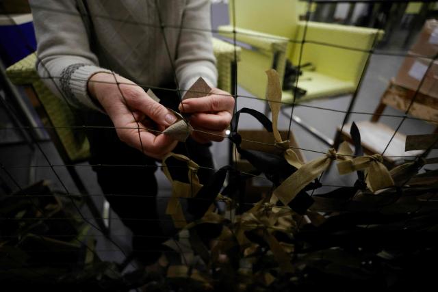 A volunteer weaves a camouflage net for the Russian army in Voronezh on January 24, 2026. (Photo by TATYANA MAKEYEVA / AFP)
