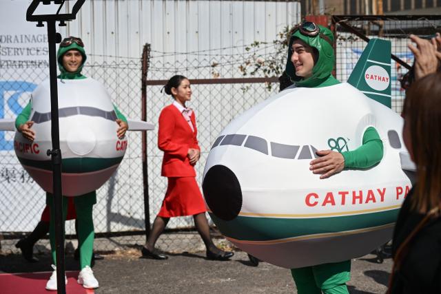 Performers on the Cathay Pacific float prepare to dance at a media preview for the upcoming Lunar New Year parade in Hong Kong on February 13, 2026, ahead of the Lunar New Year of the Horse. (Photo by Peter PARKS / AFP)