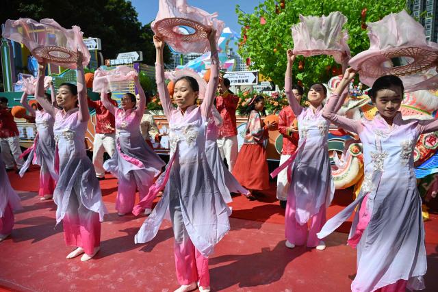 Performers dance at a media preview for the upcoming Lunar New Year parade in Hong Kong on February 13, 2026, ahead of the Lunar New Year of the Horse. (Photo by Peter PARKS / AFP)