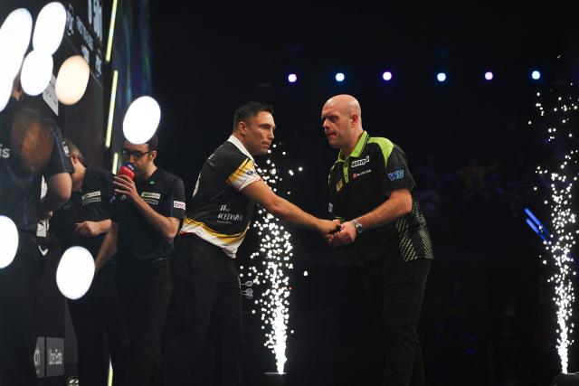 Wales' Gerwyn Price (C-L) shakes hands with Netherlands' Michael van Gerwen (C-R) after winning the final darts match on Night 2 of the Premier League Darts event in Antwerp on February 12, 2026. (Photo by ELIAS ROM / Belga / AFP) / Belgium OUT