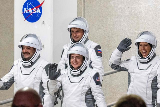 NASA astronauts Jessica Meir (C), commander, and Jack Hathaway (L), pilot, ESA (European Space Agency) astronaut Sophie Adenot (R), and Roscosmos cosmonaut Andrey Fedyaev (2ndL) walk out as they prepare to travel to the SpaceX Falcon 9 rocket with the company's Dragon spacecraft at Space Launch Complex 40 for the Crew-12 mission at Cape Canaveral Space Force Station in Florida, on February 13, 2026. (Photo by Jim WATSON / AFP)