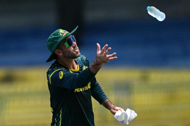Australia's Glenn Maxwell catches a water bottle during a drinks break in the 2026 ICC Men's T20 Cricket World Cup group stage match between Australia and Zimbabwe at the R Premadasa Stadium in Colombo on February 13, 2026. (Photo by Ishara S. KODIKARA / AFP)