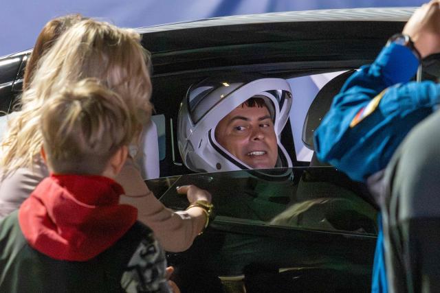 Roscosmos cosmonaut Andrey Fedyaev says goodbye as he prepares to travel to the SpaceX Falcon 9 rocket with the company's Dragon spacecraft at Space Launch Complex 40 for the Crew-12 mission launch at Cape Canaveral Space Force Station, Florida, on February 13, 2026. (Photo by Jim WATSON / AFP)