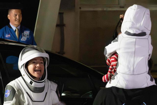 NASA astronauts Jessica Meir (L), commander, says goodbye as she prepares to travel to the SpaceX Falcon 9 rocket with the company's Dragon spacecraft at Space Launch Complex 40 for the Crew-12 mission launch at Cape Canaveral Space Force Station, Florida, on February 13, 2026. (Photo by Jim WATSON / AFP)