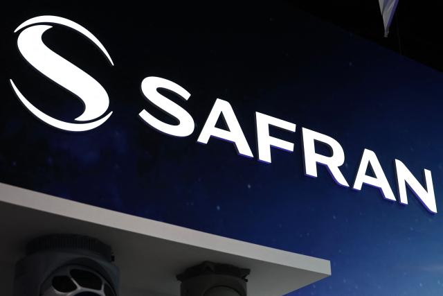 (FILES) The logo of Safran, a French multinational aerospace, defence and security corporation, is seen on their stand during the 55th edition of the International Paris Air Show (Salon international de l'aeronautique et de l'espace - SIAE) at the Paris–Le Bourget Airport, in Le Bourget, north of Paris on June 19, 2025. Safran announced on February 13, 2026 +3% adjusted net profit in 2025, which raises its forecasts through 2028. (Photo by Thibaud MORITZ / AFP)