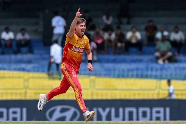 Zimbabwe's Brad Evans celebrates after taking the wicket of Australia's Cameron Green during the 2026 ICC Men's T20 Cricket World Cup group stage match between Australia and Zimbabwe at the R Premadasa Stadium in Colombo on February 13, 2026. (Photo by Ishara S. KODIKARA / AFP)