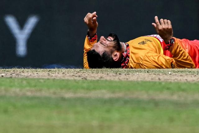 Zimbabwe's captain Sikandar Raza reacts after an injury during the 2026 ICC Men's T20 Cricket World Cup group stage match between Australia and Zimbabwe at the R Premadasa Stadium in Colombo on February 13, 2026. (Photo by Ishara S. KODIKARA / AFP)