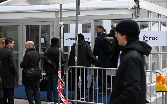 People line up at a security check to enter the Hotel Bayerischer Hof, venue of the Munich Security Conference (MSC) in Munich, southern Germany on February 13, 2026. Heads of state and government as well as foreign and defence ministers from all over the world are expected to attend the security policy talks from February 13 to 15, 2026. (Photo by THOMAS KIENZLE / AFP)