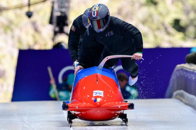 Romania's Mihai Cristian Tentea pilots in the bobsleigh men's 2-man training Heat 3 at Cortina Sliding Centre during the Milano Cortina 2026 Winter Olympic Games in Cortina d'Ampezzo on February 13, 2026. (Photo by Stefano RELLANDINI / AFP)