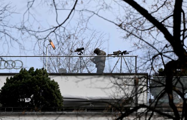 A sniper of the police stands on a roof close to the Hotel Bayerischer Hof, venue of the Munich Security Conference (MSC) in Munich, southern Germany on February 13, 2026. Heads of state and government as well as foreign and defence ministers from all over the world are expected to attend the security policy talks from February 13 to 15, 2026. (Photo by THOMAS KIENZLE / AFP)