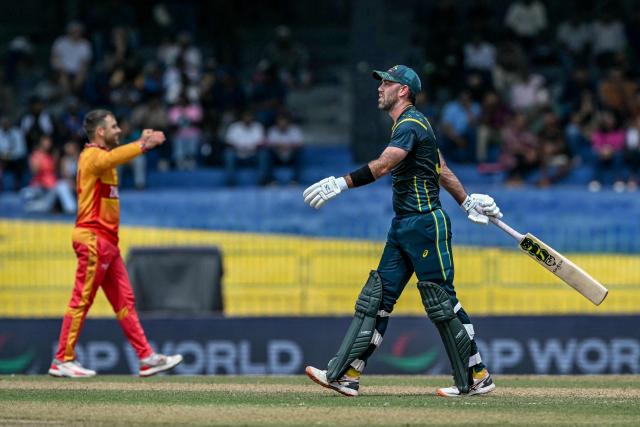 Australia's Glenn Maxwell (R) walks back to the pavilion after his dismissal by Zimbabwe's Ryan Burl (L) during the 2026 ICC Men's T20 Cricket World Cup group stage match between Australia and Zimbabwe at the R Premadasa Stadium in Colombo on February 13, 2026. (Photo by Ishara S. KODIKARA / AFP)
