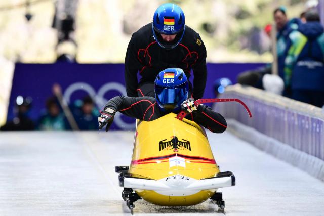 Germany's Johannes Lochner pilots in the bobsleigh men's 2-man training Heat 3 at Cortina Sliding Centre during the Milano Cortina 2026 Winter Olympic Games in Cortina d'Ampezzo on February 13, 2026. (Photo by Stefano RELLANDINI / AFP)