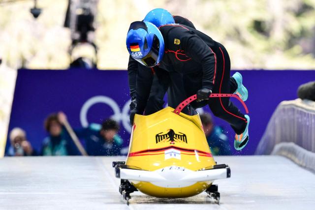 Germany's Adam Ammour pilots in the bobsleigh men's 2-man training Heat 3 at Cortina Sliding Centre during the Milano Cortina 2026 Winter Olympic Games in Cortina d'Ampezzo on February 13, 2026. (Photo by Stefano RELLANDINI / AFP)