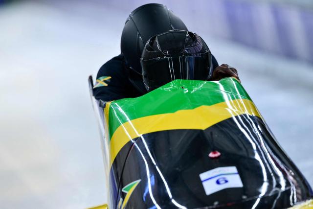 Jamaica's Shane Pitter pilots in the bobsleigh men's 2-man training Heat 3 at Cortina Sliding Centre during the Milano Cortina 2026 Winter Olympic Games in Cortina d'Ampezzo on February 13, 2026. (Photo by Stefano RELLANDINI / AFP)