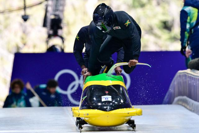 Jamaica's Shane Pitter pilots in the bobsleigh men's 2-man training Heat 3 at Cortina Sliding Centre during the Milano Cortina 2026 Winter Olympic Games in Cortina d'Ampezzo on February 13, 2026. (Photo by Stefano RELLANDINI / AFP)