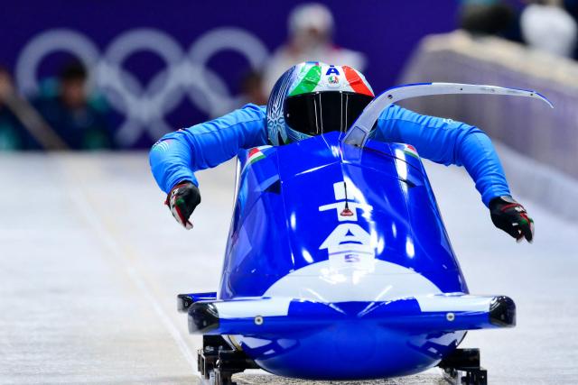 Italy's Patrick Baumgartner pilots in the bobsleigh men's 2-man training Heat 3 at Cortina Sliding Centre during the Milano Cortina 2026 Winter Olympic Games in Cortina d'Ampezzo on February 13, 2026. (Photo by Stefano RELLANDINI / AFP)