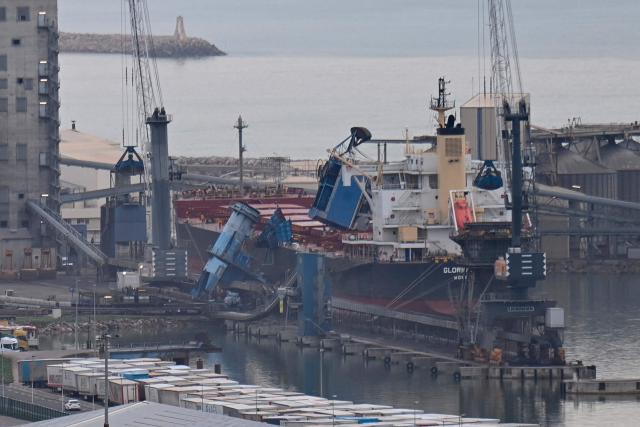 This photograph shows a 550-ton crane collapsed onto a cargo ship at the port of Sete, southern France on February 13, 2026, following the violent winds of Storm Nils. (Photo by Sylvain THOMAS / AFP)