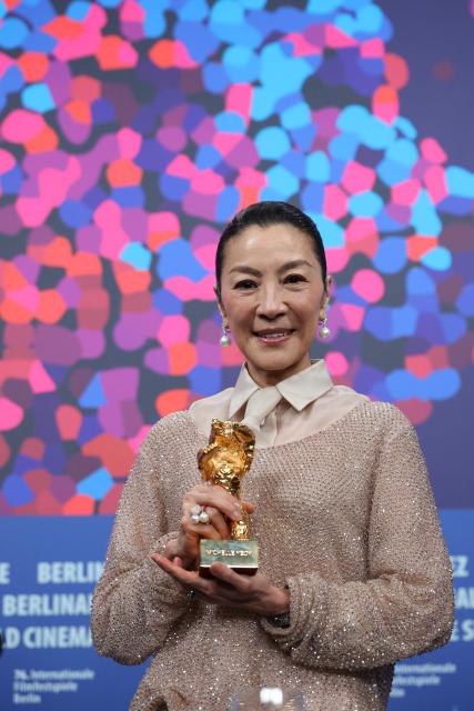 Malaysian actress Michelle Yeoh holds the Honorary Golden Bear trophy she was awarded "in recognition of her outstanding achievements in film and cinema" at a press conference during the Berlinale, Europe's first major film festival of the year, in Berlin on February 13, 2026. (Photo by Ronny HARTMANN / AFP)