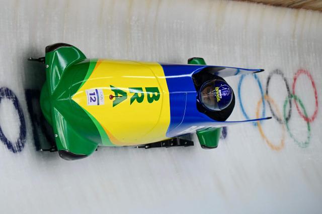Brazil's Edson Luques Bindilatti pilots in the bobsleigh men's 2-man training Heat 4 at Cortina Sliding Centre during the Milano Cortina 2026 Winter Olympic Games in Cortina d'Ampezzo on February 13, 2026. (Photo by Stefano RELLANDINI / AFP)