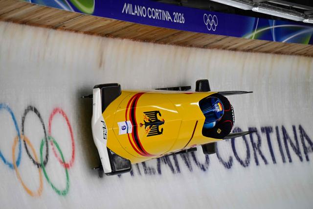 Germany's Johannes Lochner pilots in the bobsleigh men's 2-man training Heat 4 at Cortina Sliding Centre during the Milano Cortina 2026 Winter Olympic Games in Cortina d'Ampezzo on February 13, 2026. (Photo by Stefano RELLANDINI / AFP)
