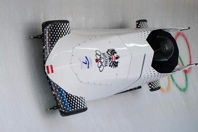 Austria's Markus Treichl pilots in the bobsleigh men's 2-man training Heat 4 at Cortina Sliding Centre during the Milano Cortina 2026 Winter Olympic Games in Cortina d'Ampezzo on February 13, 2026. (Photo by Stefano RELLANDINI / AFP)