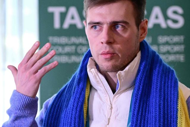 Ukrainian skeleton athlete Vladyslav Heraskevych speaks to the press after a hearing at the Court of Arbitration for Sport (TAS) in Milan on February 13, 2026. Heraskevych was barred from the Milan-Cortina Games after refusing to back down from wearing a helmet adorned with pictures of Ukrainian sportsmen and women killed since Russian invaded in 2022. (Photo by Piero CRUCIATTI / AFP)