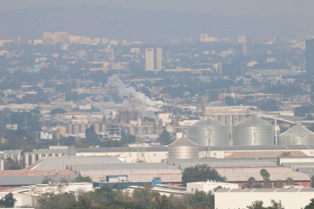 This aerial view shows buildings amid air pollution in Guadalajara, Mexico on February 5, 2026. Lower blood oxygenation, greater physical exertion and increased ball speed are the challenges that Mexico City's altitude of 2,240 metres presents to the footballers who will play at the Azteca Stadium during the 2026 FIFA World Cup. (Photo by ULISES RUIZ / AFP)