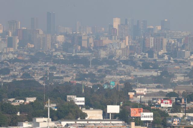 This aerial view shows buildings amid air pollution in Guadalajara, Mexico on February 5, 2026. Lower blood oxygenation, greater physical exertion and increased ball speed are the challenges that Mexico City's altitude of 2,240 metres presents to the footballers who will play at the Azteca Stadium during the 2026 FIFA World Cup. (Photo by ULISES RUIZ / AFP)