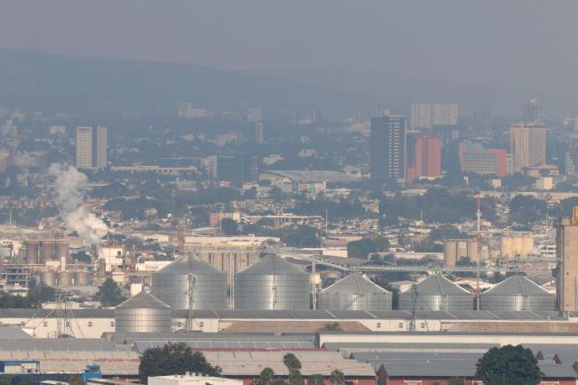 This aerial view shows buildings amid air pollution in Guadalajara, Mexico on February 5, 2026. Lower blood oxygenation, greater physical exertion and increased ball speed are the challenges that Mexico City's altitude of 2,240 metres presents to the footballers who will play at the Azteca Stadium during the 2026 FIFA World Cup. (Photo by ULISES RUIZ / AFP)