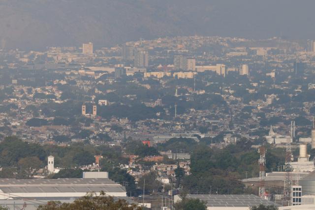 This aerial view shows buildings amid air pollution in Guadalajara, Mexico on February 5, 2026. Lower blood oxygenation, greater physical exertion and increased ball speed are the challenges that Mexico City's altitude of 2,240 metres presents to the footballers who will play at the Azteca Stadium during the 2026 FIFA World Cup. (Photo by ULISES RUIZ / AFP)