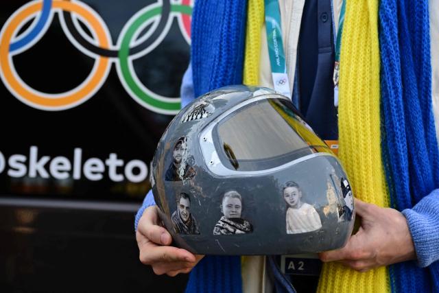 Ukrainian skeleton athlete Vladyslav Heraskevych poses with his helmet after a hearing at the Court of Arbitration for Sport (TAS) in Milan on February 13, 2026. Heraskevych was barred from the Milan-Cortina Games after refusing to back down from wearing a helmet adorned with pictures of Ukrainian sportsmen and women killed since Russian invaded in 2022. (Photo by Piero CRUCIATTI / AFP)