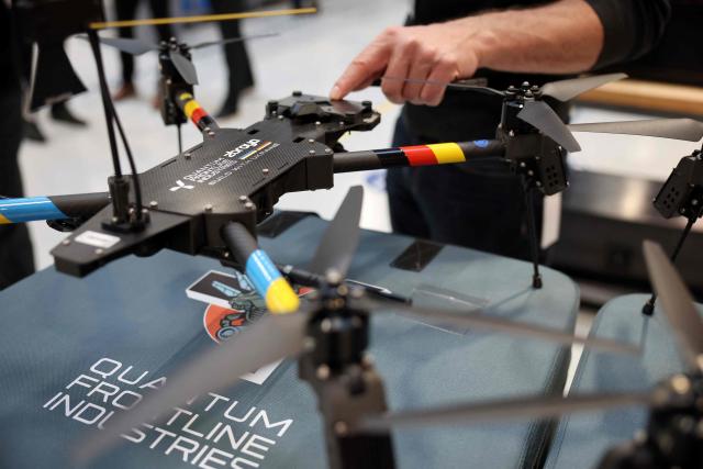 A drone is decorated in the colors of Ukraine and Germany, pictured during a visit of the Ukrainian President and the German Defence Minister at the production facility of drone producing company Quantum Frontline Industries (QFI) in Gilching near Munich, southern Germany, on the sidelines of the 62nd Munich Security Conference (MSC) on February 13, 2026. Heads of state and government as well as foreign and defence ministers from all over the world are expected to attend the security policy talks from February 13 to 15, 2026. (Photo by Alexandra BEIER / AFP)