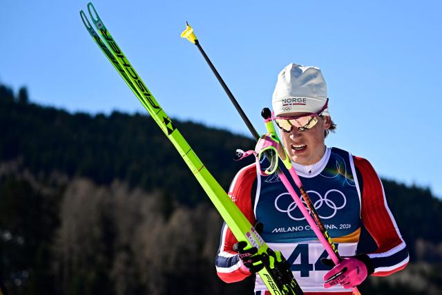 Norway's Johannes Hoesflot Klaebo reacts after crossing the finish line during the men's 10km cross-country interval start free event of the Milano Cortina 2026 Winter Olympic Games at Tesero Cross-Country Skiing Stadium in Lago di Tesero (Val di Fiemme) on February 13, 2026. (Photo by Tobias SCHWARZ / AFP)