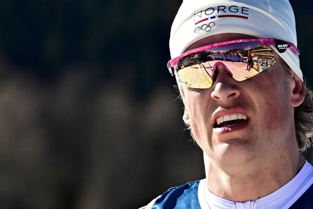 Norway's Johannes Hoesflot Klaebo reacts after crossing the finish line during the men's 10km cross-country interval start free event of the Milano Cortina 2026 Winter Olympic Games at Tesero Cross-Country Skiing Stadium in Lago di Tesero (Val di Fiemme) on February 13, 2026. (Photo by Tobias SCHWARZ / AFP)