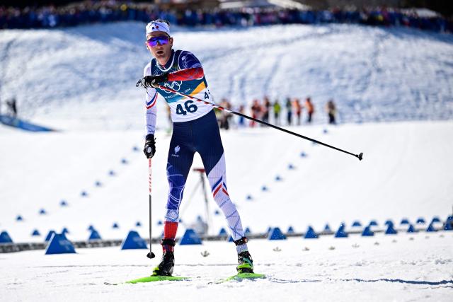France's Mathis Desloges reacts after crossing the finish line during the men's 10km cross-country interval start free event of the Milano Cortina 2026 Winter Olympic Games at Tesero Cross-Country Skiing Stadium in Lago di Tesero (Val di Fiemme) on February 13, 2026. (Photo by Tobias SCHWARZ / AFP)