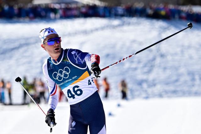 France's Mathis Desloges crosses the finish line during the men's 10km cross-country interval start free event of the Milano Cortina 2026 Winter Olympic Games at Tesero Cross-Country Skiing Stadium in Lago di Tesero (Val di Fiemme) on February 13, 2026. (Photo by Tobias SCHWARZ / AFP)