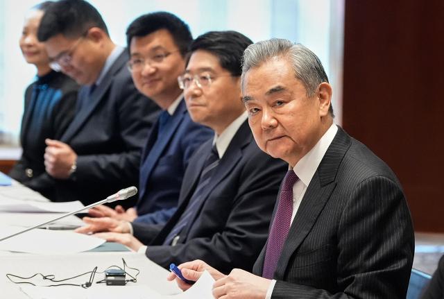 China's Foreign Minister Wang Yi (R) attends a bilateral meeting with the US Secretary of State (not in picture) in Munich, on February 13, 2026, on the sidelines of the Munich Security Conference (MSC). Heads of state and government as well as foreign and defence ministers from all over the world are expected to attend the security policy talks from February 13 to 15, 2026. (Photo by Alex Brandon / POOL / AFP)