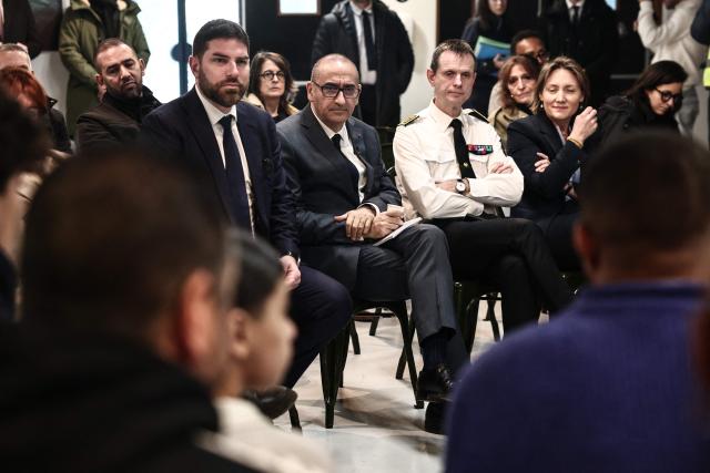 France's Interior Minister Laurent Nunez (C) flanked by France's Housing Minister Vincent Jeanbrun (C-L) and Prefect of Marseille Jacques Witkowski (C-R) listen to association members at the ZEF theater to discuss prevention and urban policy during his visit to Marseille, southern France on February 13, 2026. (Photo by Thibaud MORITZ / AFP)