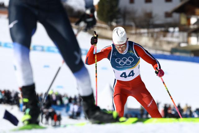 Norway's Johannes Hoesflot Klaebo (R) competes during the men's 10km cross-country interval start free event of the Milano Cortina 2026 Winter Olympic Games at Tesero Cross-Country Skiing Stadium in Lago di Tesero (Val di Fiemme) on February 13, 2026. (Photo by Anne-Christine POUJOULAT / AFP)