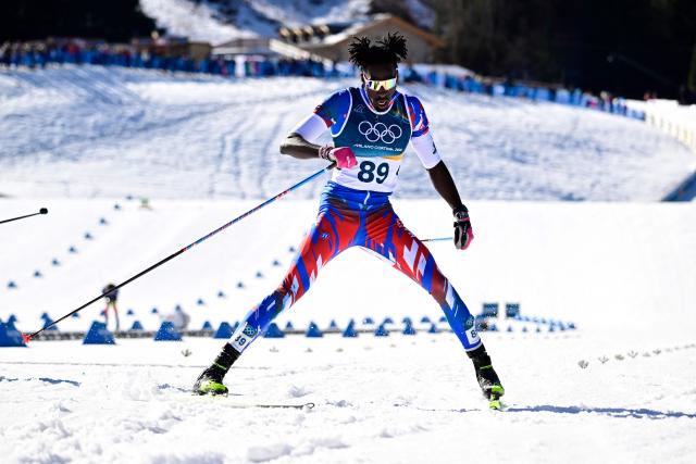 Haiti's Stevenson Savart reacts after crossing the finish line during the men's 10km cross-country interval start free event of the Milano Cortina 2026 Winter Olympic Games at Tesero Cross-Country Skiing Stadium in Lago di Tesero (Val di Fiemme) on February 13, 2026. (Photo by Tobias SCHWARZ / AFP)