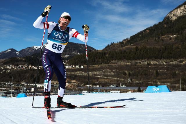 USA's Gus Schumacher competes during the men's 10km cross-country interval start free event of the Milano Cortina 2026 Winter Olympic Games at Tesero Cross-Country Skiing Stadium in Lago di Tesero (Val di Fiemme) on February 13, 2026. (Photo by Anne-Christine POUJOULAT / AFP)