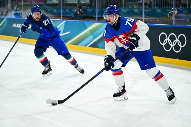 Slovakia's #79 Libor Hudacek (R) controls the puck past Italy's #21 Daniel Glira during the men's preliminary round Group B Ice Hockey match between Italy and Slovakia at the Milano Rho Ice Hockey Arena at the Milano Cortina 2026 Winter Olympic Games in Milan, on February 13, 2026. (Photo by JULIEN DE ROSA / AFP)