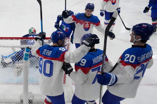 Slovakia's #79 Libor Hudacek (C) celebrates with teammates after scoring his team first goal during the men's preliminary round Group B Ice Hockey match between Italy and Slovakia at the Milano Rho Ice Hockey Arena at the Milano Cortina 2026 Winter Olympic Games in Milan, on February 13, 2026. (Photo by Darko Bandic / POOL / AFP)