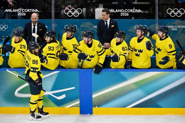 Sweden's players celebrate a team goal  during the men's preliminary round Group B Ice Hockey match between Finland and Sweden at the Milano Santagiulia Ice Hockey Arena during the Milano Cortina 2026 Winter Olympic Games in Milan, on February 13, 2026. (Photo by Alexander NEMENOV / AFP)