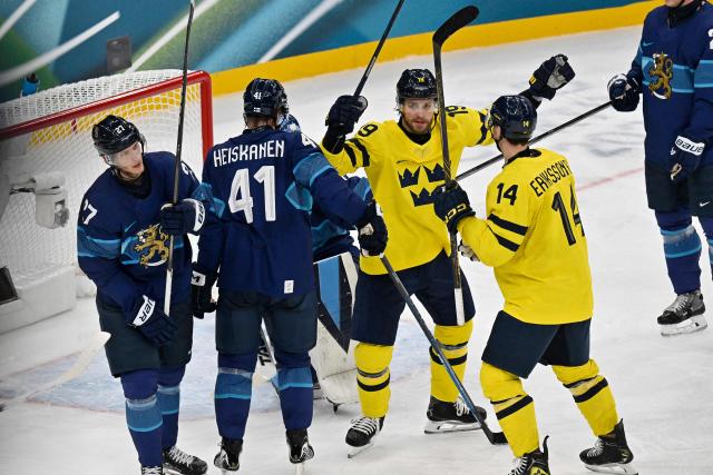Sweden's #19 Adrian Kempe (C) celebrates a team goal  during the men's preliminary round Group B Ice Hockey match between Finland and Sweden at the Milano Santagiulia Ice Hockey Arena during the Milano Cortina 2026 Winter Olympic Games in Milan, on February 13, 2026. (Photo by Alexander NEMENOV / AFP)