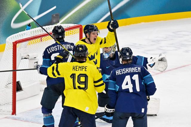 Sweden's #14 Joel Eriksson Ek celebrates a team goal  during the men's preliminary round Group B Ice Hockey match between Finland and Sweden at the Milano Santagiulia Ice Hockey Arena during the Milano Cortina 2026 Winter Olympic Games in Milan, on February 13, 2026. (Photo by Alexander NEMENOV / AFP)