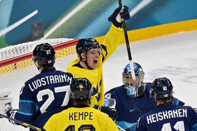 Sweden's #14 Joel Eriksson Ek celebrates a team goal  during the men's preliminary round Group B Ice Hockey match between Finland and Sweden at the Milano Santagiulia Ice Hockey Arena during the Milano Cortina 2026 Winter Olympic Games in Milan, on February 13, 2026. (Photo by Alexander NEMENOV / AFP)