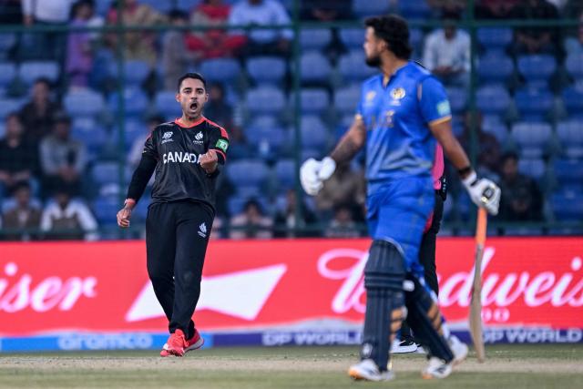 Canada's Saad Bin Zafar (L) celebrates after taking the wicket of UAE's Mayank Kumar (R) during the 2026 ICC Men's T20 Cricket World Cup group stage match between Canada and United Arab Emirates at the Arun Jaitley Stadium in New Delhi on February 13, 2026. (Photo by Arun SANKAR / AFP)