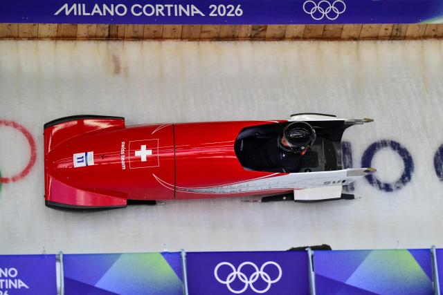 Switzerland's Melanie Hasler pilots in the bobsleigh women's monobob training Heat 4 at Cortina Sliding Centre during the Milano Cortina 2026 Winter Olympic Games in Cortina d'Ampezzo on February 13, 2026. (Photo by Stefano RELLANDINI / AFP)